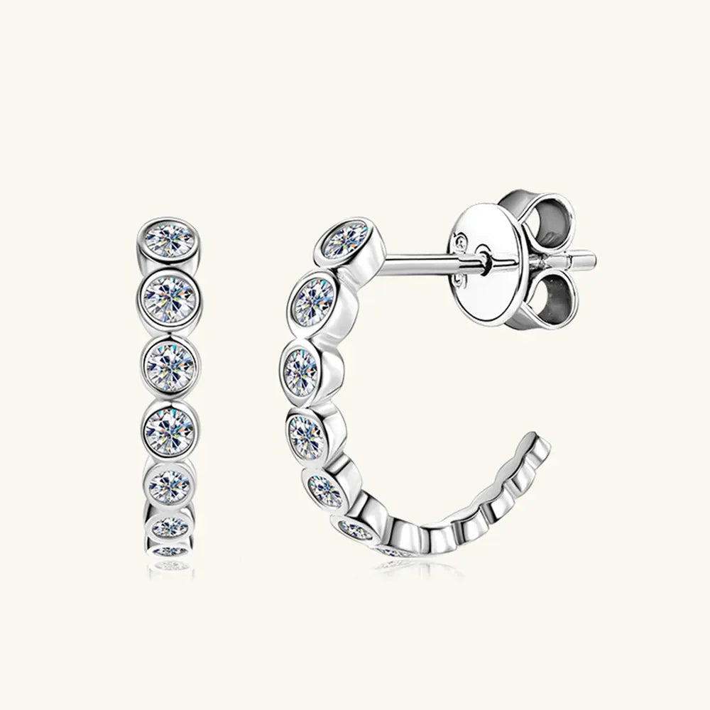 Silver moissanite pavé hoop earrings with bezel-set round stones.