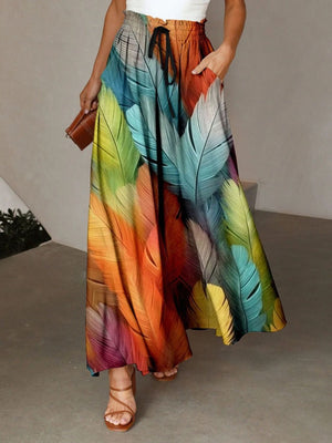 Maxi skirt with multicolor feather print, adjustable drawstring waist, and pockets.