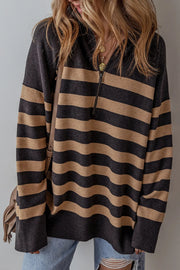 Oversized black and tan striped knit pullover with half-zip neckline and ribbed cuffs.