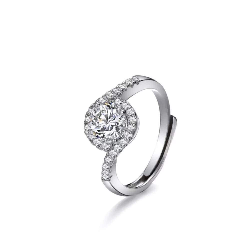 Silver moissanite halo ring with a round center stone and pave band.