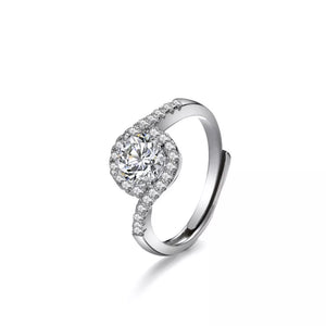 Silver moissanite halo ring with a round center stone and pave band.
