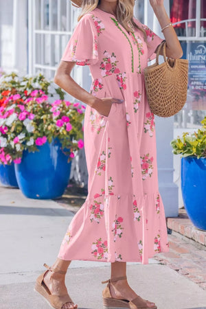Pink floral cotton midi dress with flutter sleeves and tiered hem.