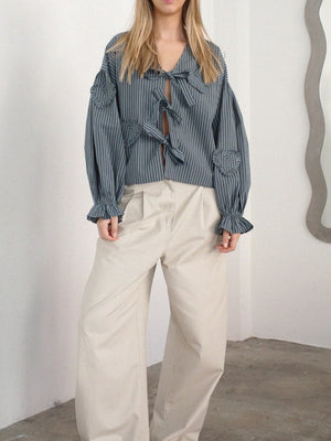 Striped blouse with heart appliqués and tie front, featuring puffed sleeves and ruffled cuffs.