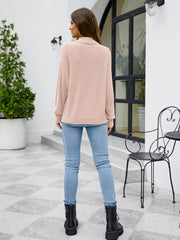 Blush pink textured mock neck knit sweater with long sleeves.