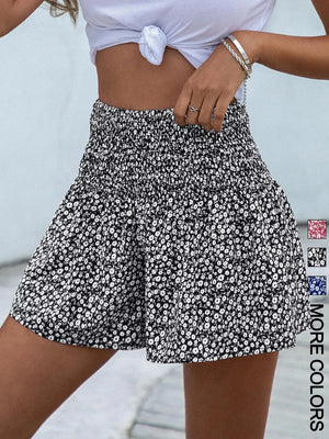 Black floral chino shorts with elastic smocked waist and a-line cut.