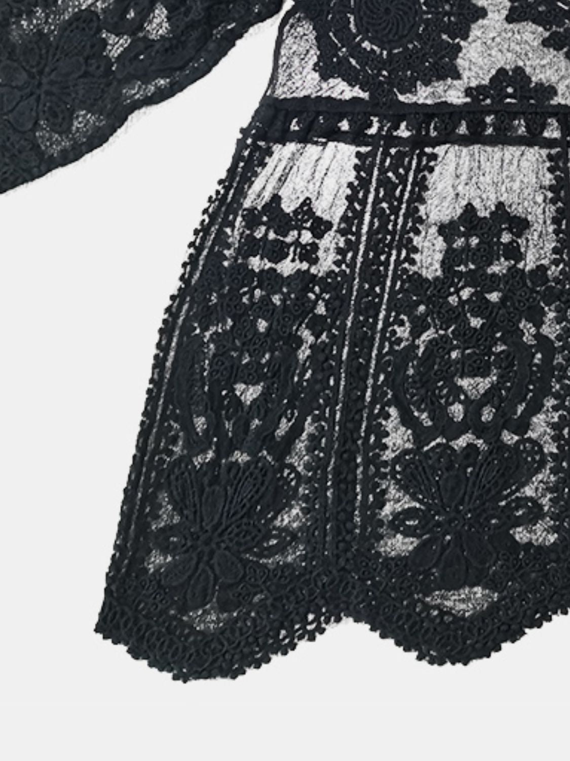 Black embroidered crochet kaftan cover-up with intricate floral details and scalloped hem.