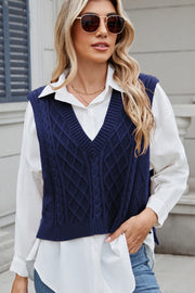 Dark Navy cable knit diamond vest with V-neck, acrylic material, styled over a white shirt.