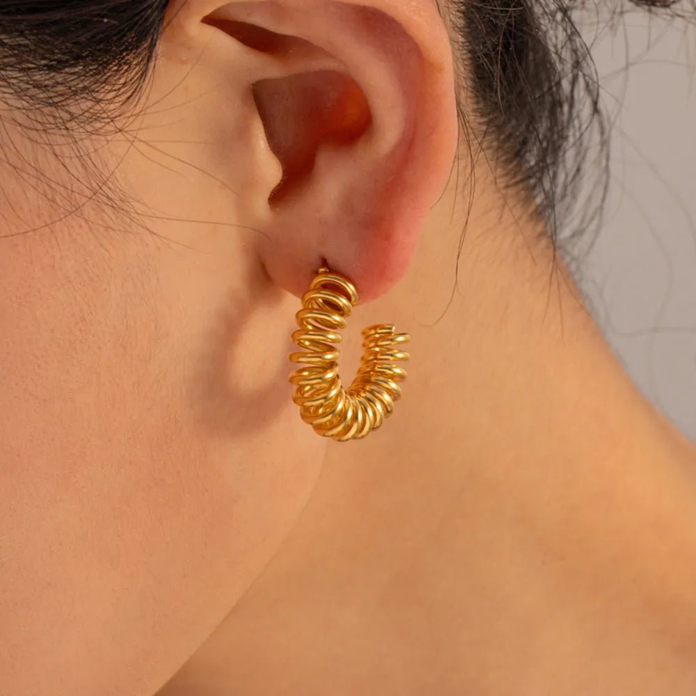 Gold vermeil spiral coil hoop earrings with a coiled design.