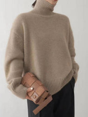 Relaxed fit cashmere turtleneck sweater in khaki with a high neck and ribbed cuffs.