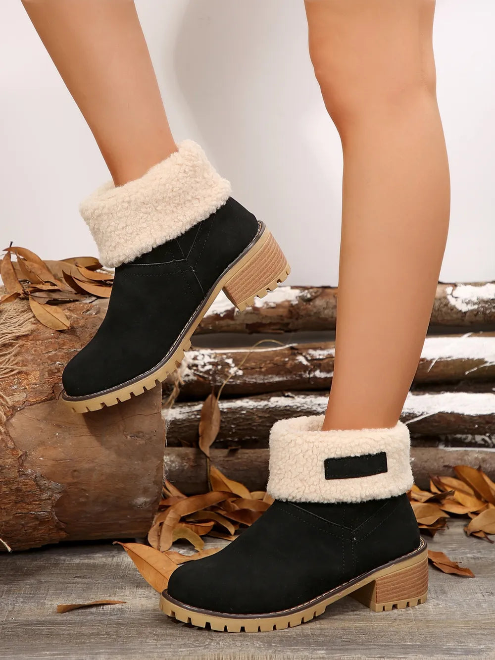Black suede ankle boots with sherpa trim and block heel.