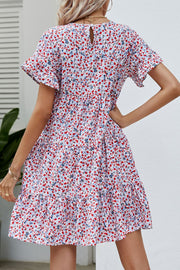 Miniature floral tiered babydoll dress with short flutter sleeves and keyhole back.