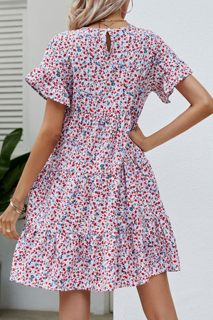Miniature floral tiered babydoll dress with short flutter sleeves and keyhole back.