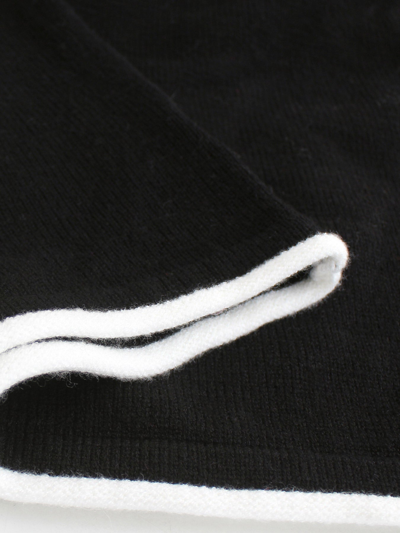 Black maxi dress detail with white ruffled trim neckline