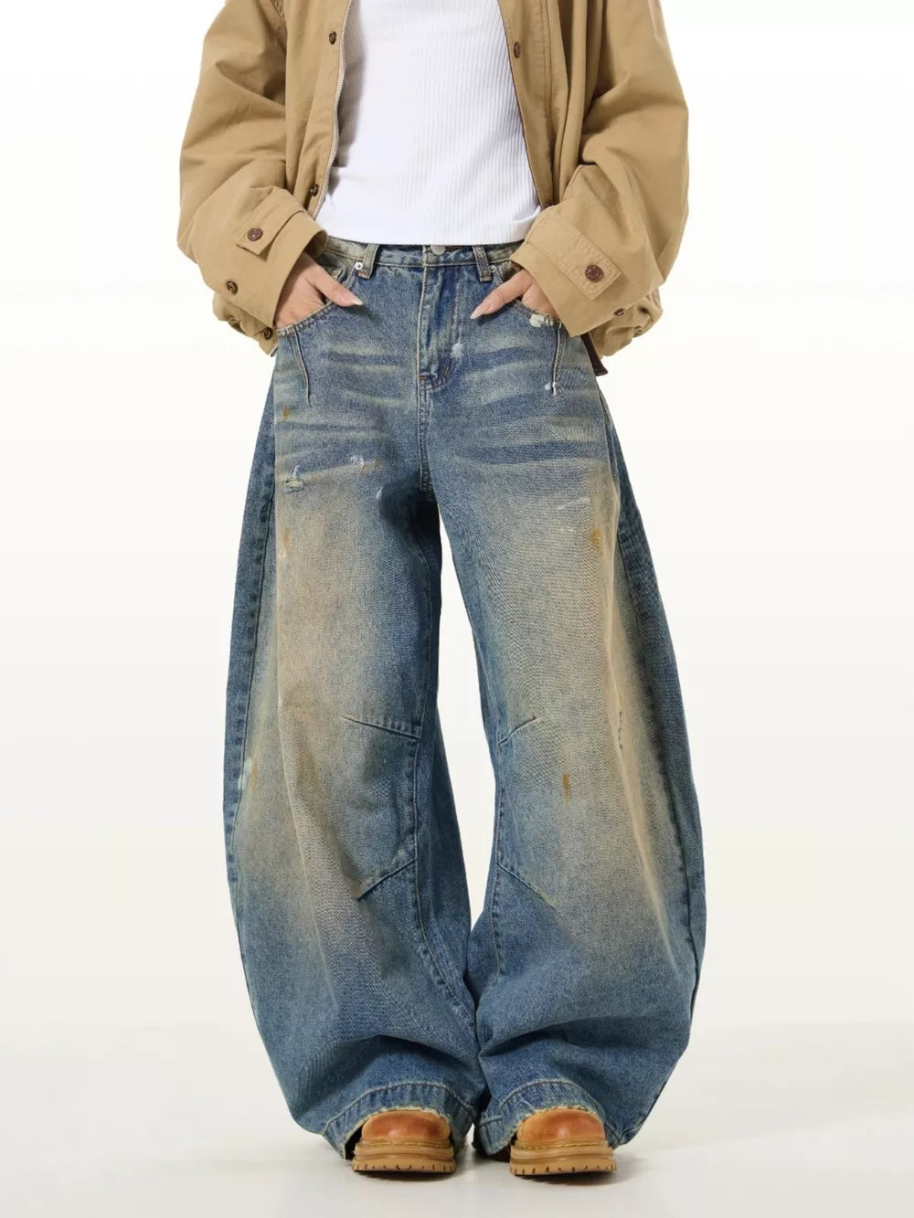 Vintage washed oversized men's jeans in blue denim with distressed details and wide leg.