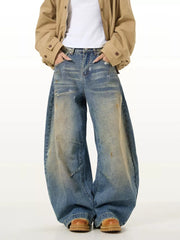 Vintage washed oversized men's jeans in blue denim with distressed details and wide leg.
