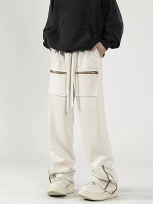 Apricot sweatpants with relaxed fit, drawstring waist, and zipper pockets.