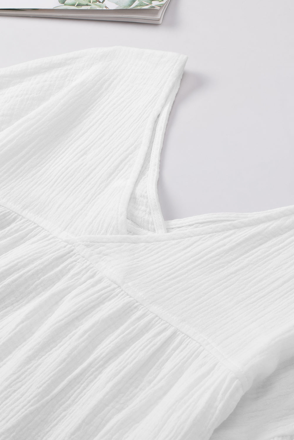 White textured gauze blouse with gathered detail at neckline and empire waist.
