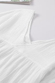 White textured gauze blouse with gathered detail at neckline and empire waist.