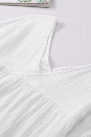 White textured gauze blouse with gathered detail at neckline and empire waist.