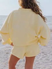 Yellow crew neck sweatshirt and shorts lounge set on beach