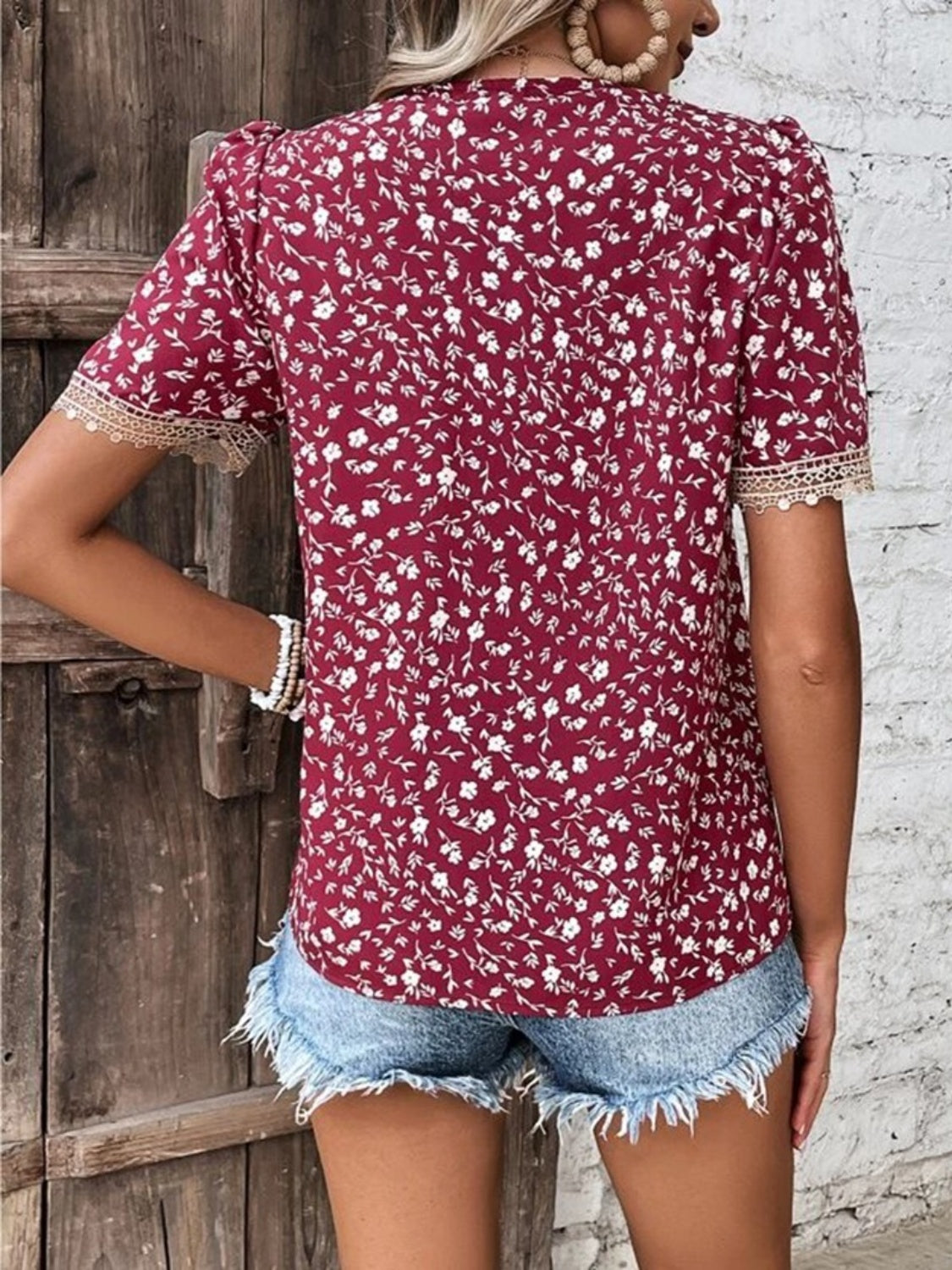 Floral lace trim short sleeve blouse with V-neck and allover floral print.