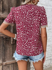 Floral lace trim short sleeve blouse with V-neck and allover floral print.