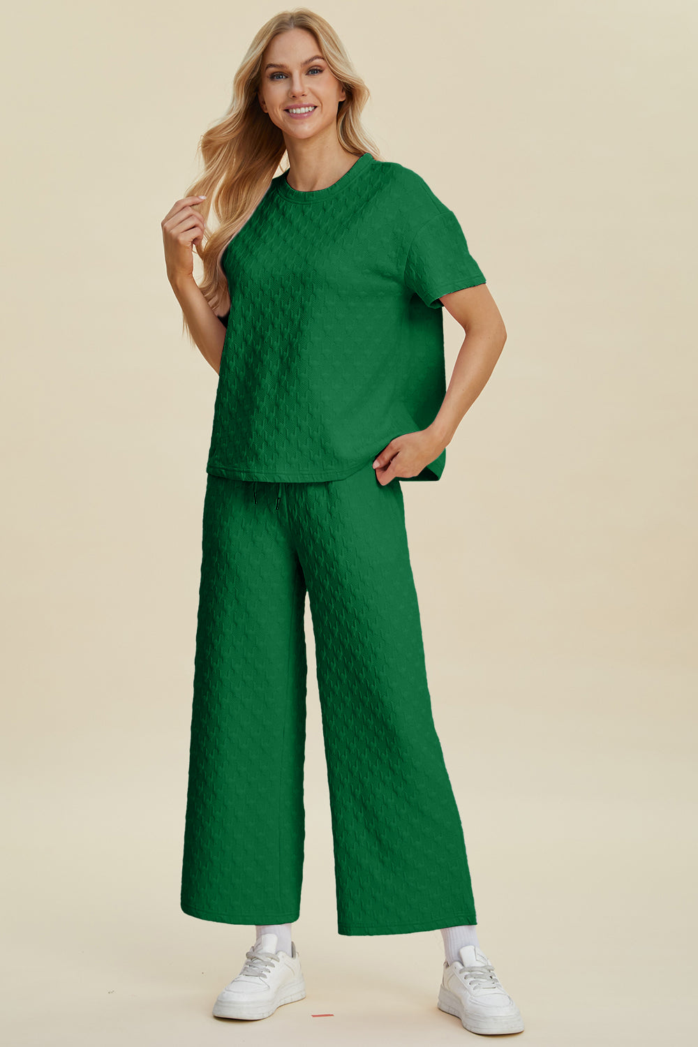 Dark green textured knit lounge set with wide leg pants and a short sleeve top.