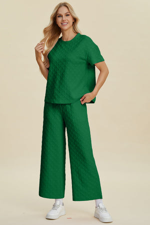 Dark green textured knit lounge set with wide leg pants and a short sleeve top.