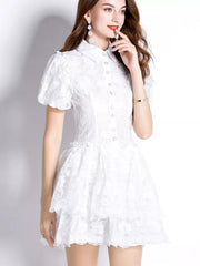 White lace mini dress with puff sleeves, collared neckline, and tiered ruffled skirt.