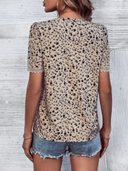 Tan floral print blouse with V-neck and lace trim on short sleeves.