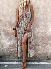 Multicolor paisley print maxi dress with cinched waist and dramatic slit.