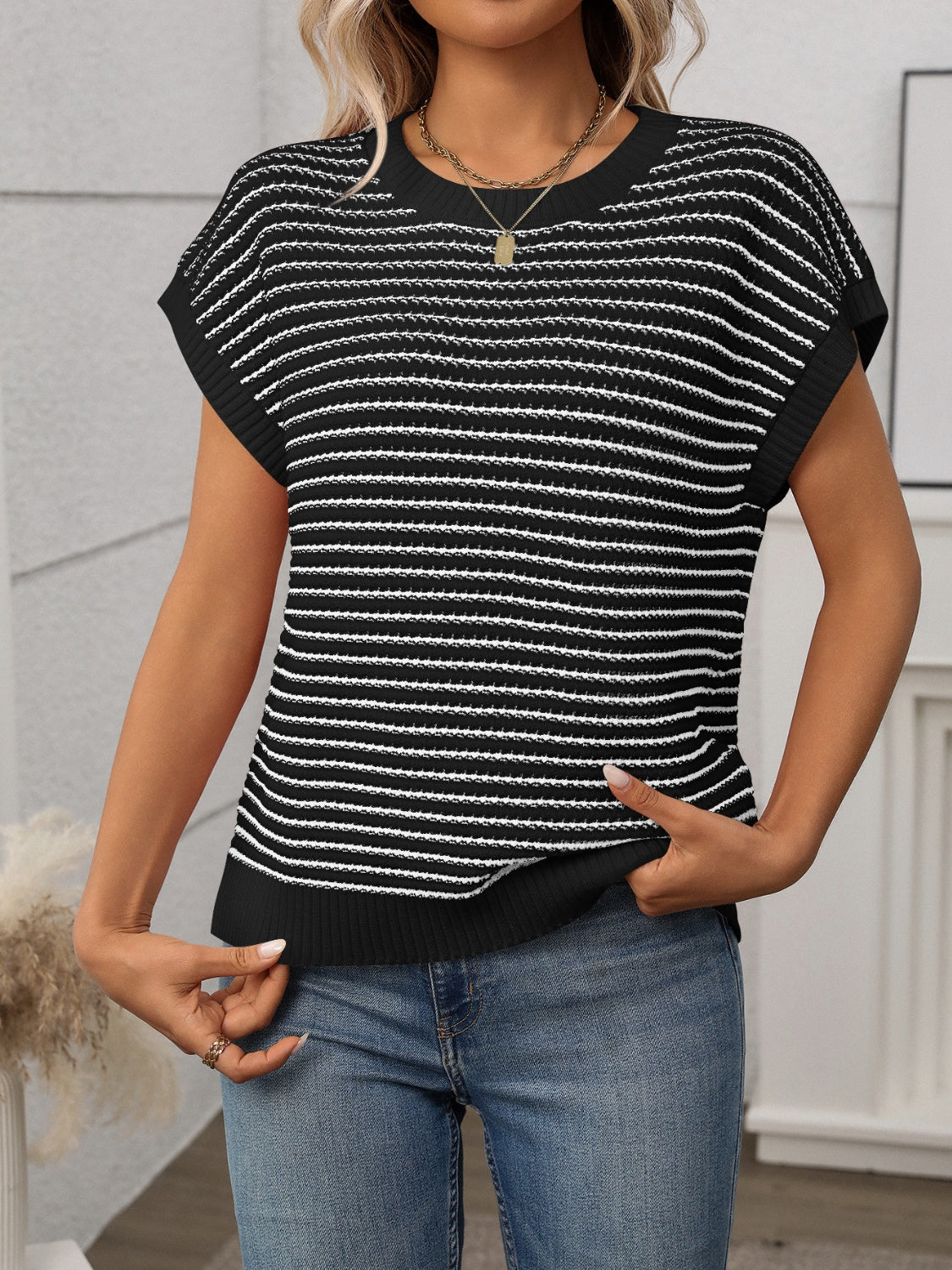 Black and white horizontal stripe knit shell sweater with short sleeves and crew neck.