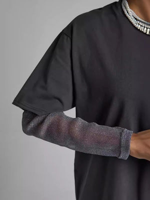 Oversized black t-shirt with sheer, ribbed, metallic sleeves.