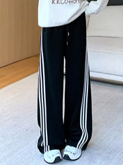 Black wide-leg maternity joggers with white side stripes and drawstring waist.