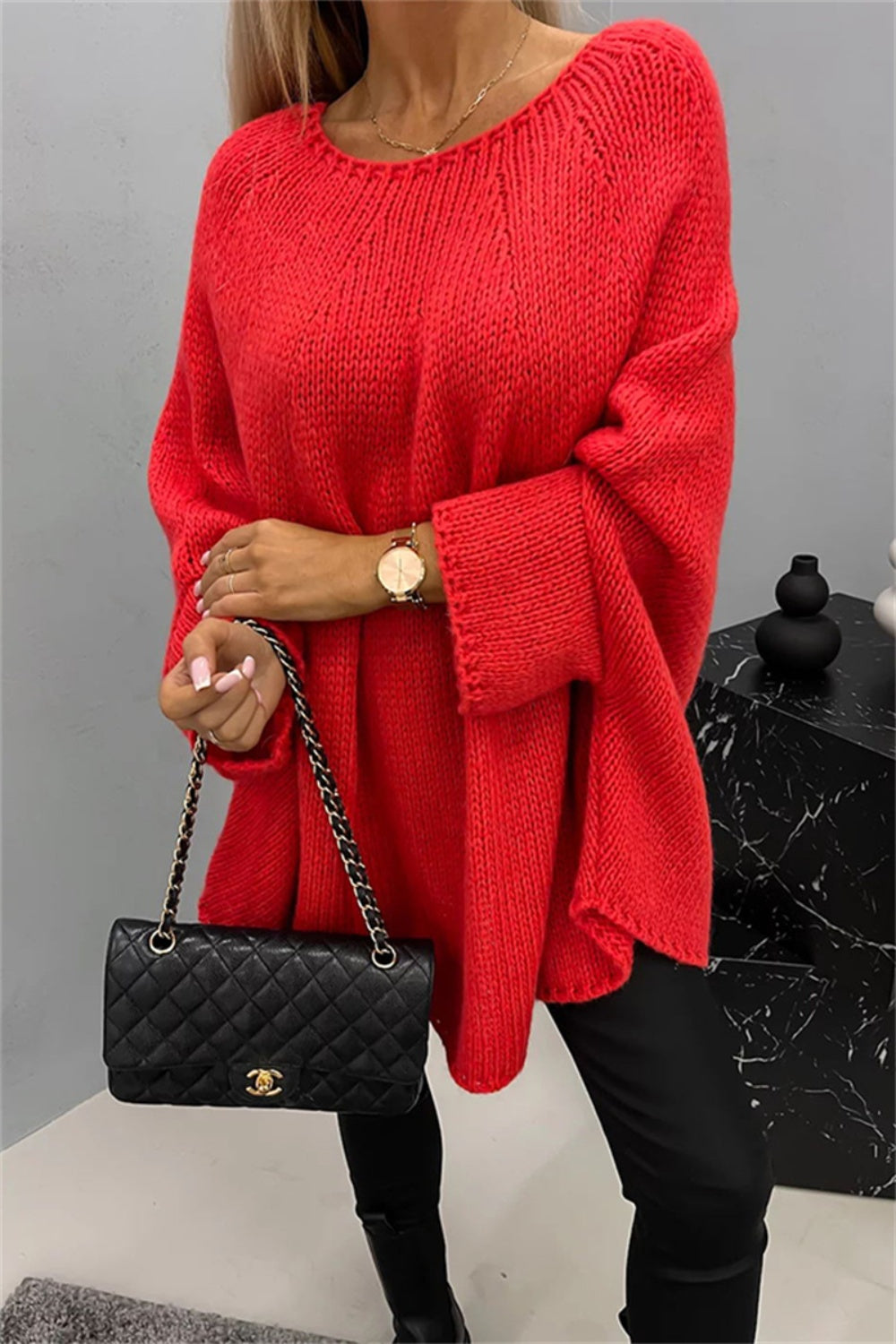 Relaxed knit sweater in Deep Red with cape sleeves and a round neckline.
