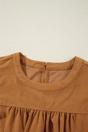 Caramel corduroy babydoll mini dress with round neckline and back button closure.