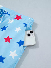Starry drawstring mini skort with pockets in light blue with red and blue stars.