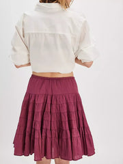 Tiered drawstring mini skirt in a deep berry color with ruffled tiers.
