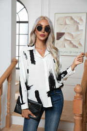 White silk-blend button-down blouse with black brushstroke print and collar.