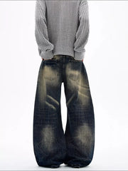 Men's vintage wash wide leg jeans in dark blue denim with distressed details.