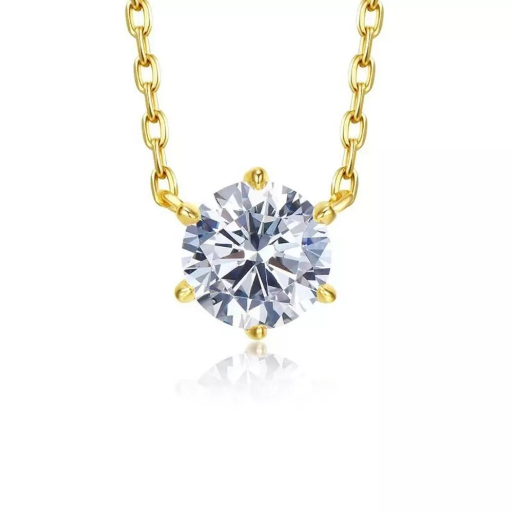 Sterling silver necklace with a clear zircon pendant and gold chain.