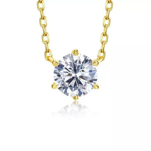 Sterling silver necklace with a clear zircon pendant and gold chain.