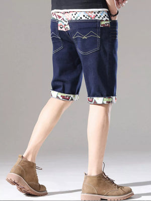 Men's dark blue denim shorts with rolled cuffs and a patterned waistband.