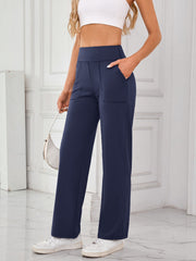 Dark navy wide-leg lounge trousers with patch pockets and contrast stitching.