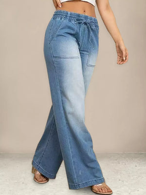 Light blue denim maternity jeans with drawstring waist and wide legs.