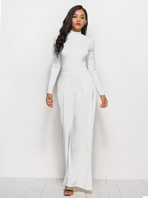 White high-waisted palazzo jumpsuit with slit front and long sleeves.