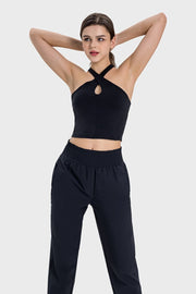 Black keyhole halter crop top with crisscross neckline.