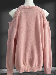 Pink cold shoulder knit sweater with crew neck and ribbed cuffs and hem.