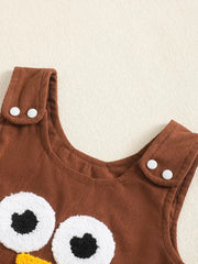 Brown corduroy baby dress with turkey applique and white button straps.