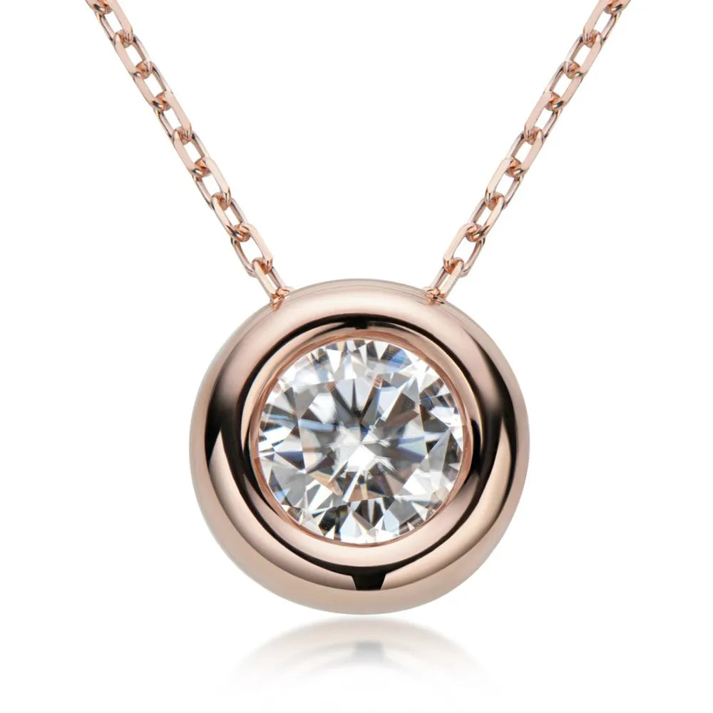 Rose gold solitaire pendant necklace with bezel-set diamond on a delicate chain.